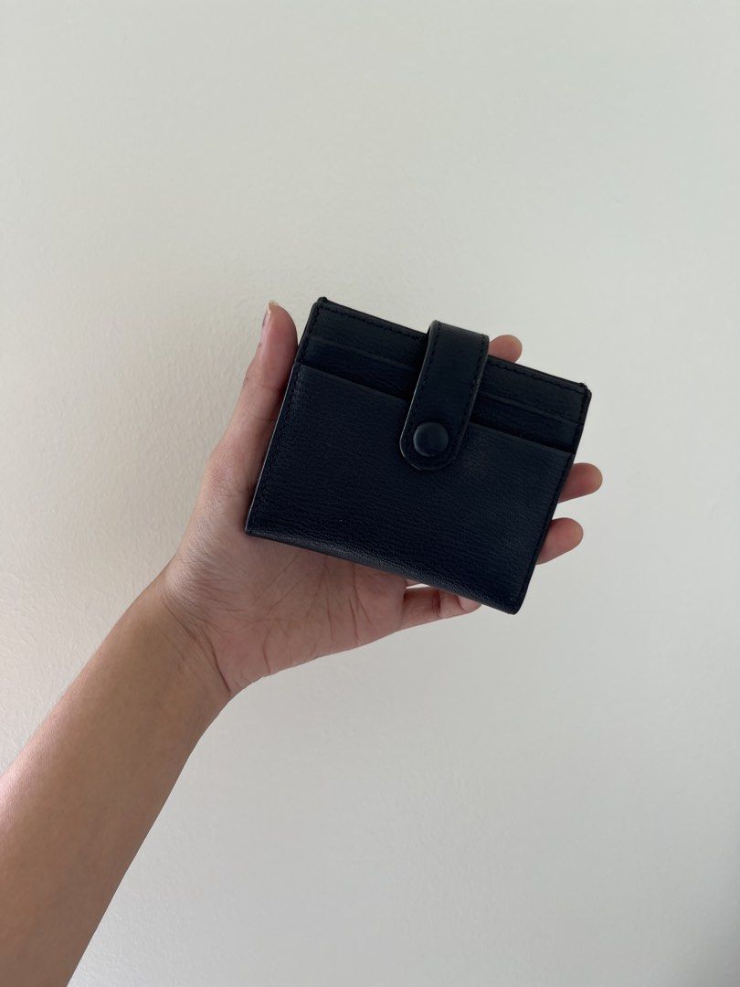 CHARLES & KEITH | Black Leather Card Holder Wallet (Category: Wallets & Card holders) located in Mandaluyong City. Submitted by bravedeer.020ad7 (Listing ID 1468308409, Image 2). Description: - Color & Texture: Stylish black textured design - Closure: Secure front snap button strap - Storage: Multiple exterior card slots on both sides - Size: Compact and pocket-friendly - Quality: Clean stitching throughout.