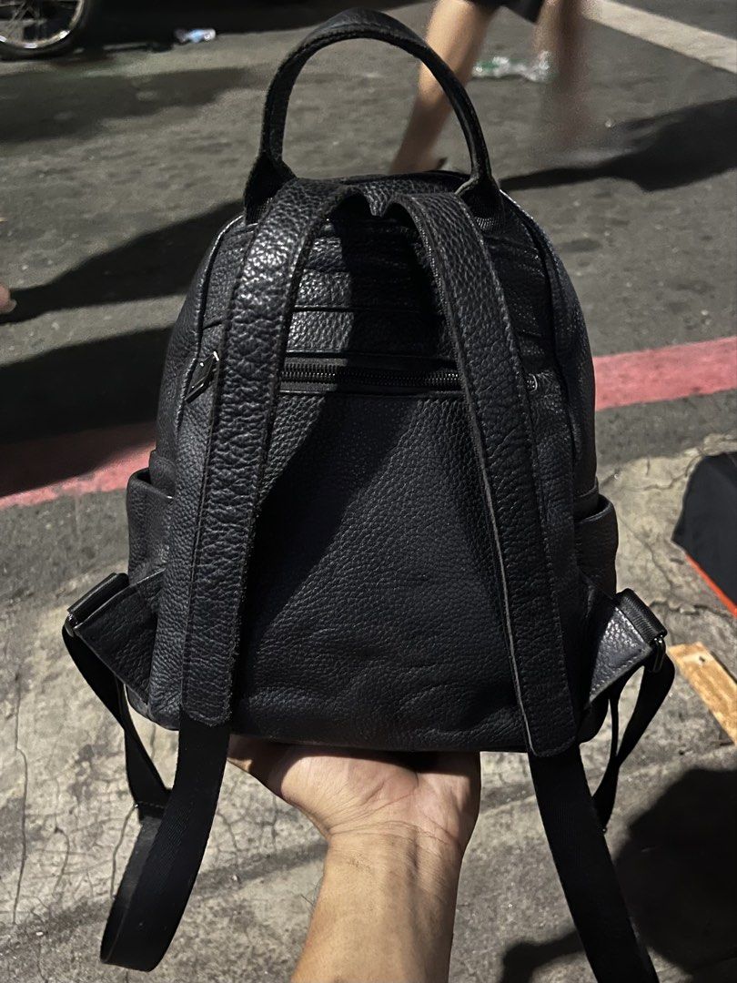 Black Leather Mini Backpack with silver Man Emblem (Category: Backpacks) located in Marikina City. Submitted by baron0923 (Listing ID 1468453785, Image 3). Description: - Stylish black pebble leather mini backpack - Distinctive metal Green Man leaf face emblem on the front - Secure main compartment with smooth zipper closure - Handy front zipper pocket and side slip pockets - Comfortable adjustable straps and top grab handle - Clean interior lini