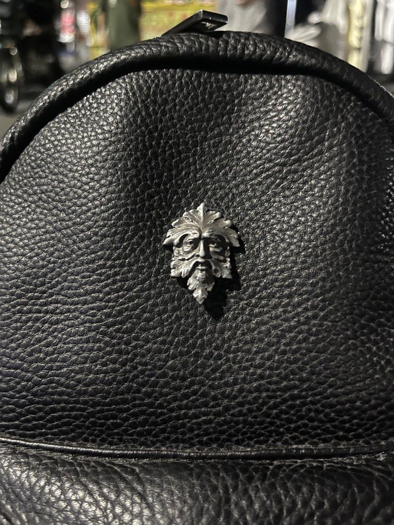 Black Leather Mini Backpack with silver Man Emblem (Category: Backpacks) located in Marikina City. Submitted by baron0923 (Listing ID 1468453785, Image 1). Description: - Stylish black pebble leather mini backpack - Distinctive metal Green Man leaf face emblem on the front - Secure main compartment with smooth zipper closure - Handy front zipper pocket and side slip pockets - Comfortable adjustable straps and top grab handle - Clean interior lini