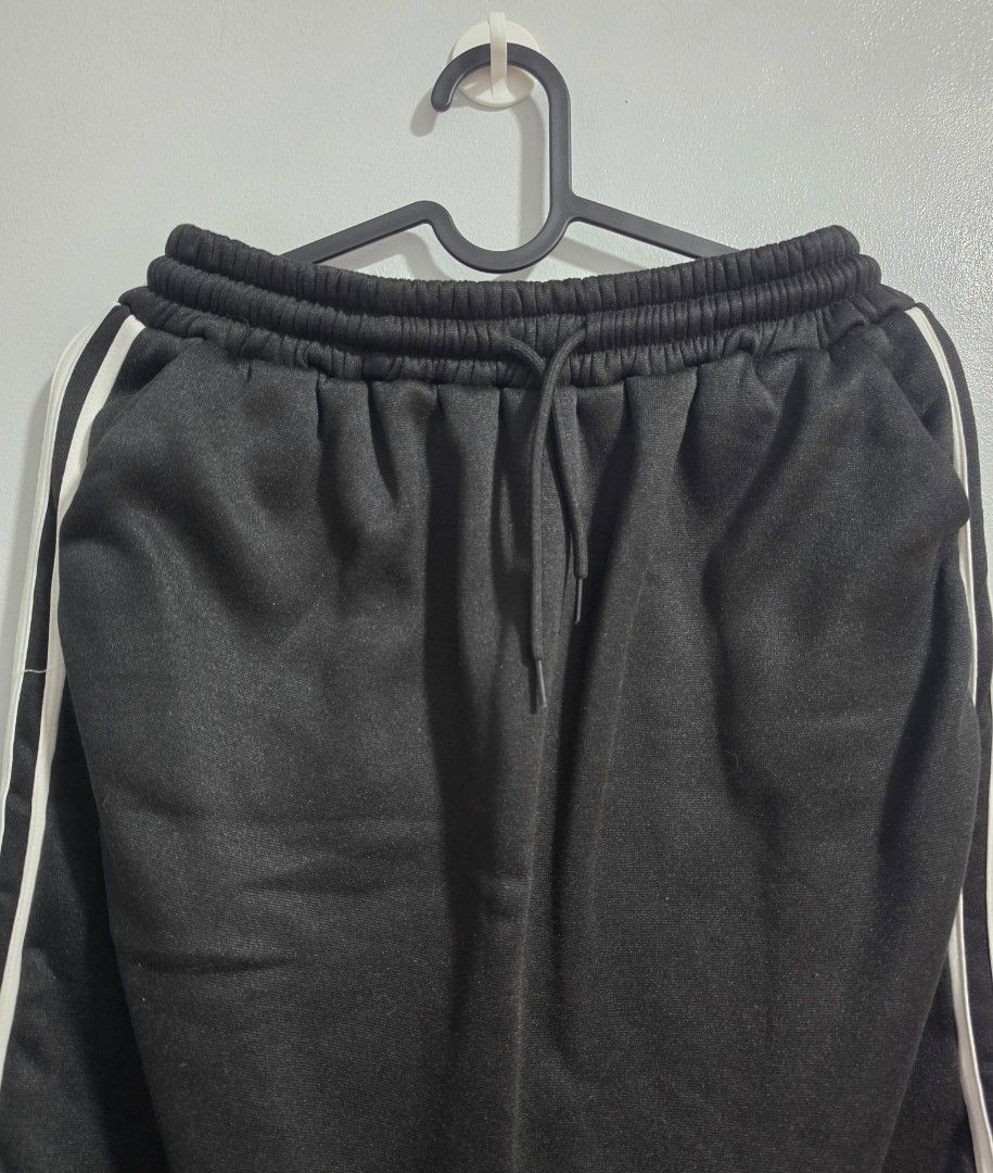Black Long Skirt with White Side Stripes (Category: Skirts) located in Paranaque City. Submitted by franinnashop (Listing ID 1468372921, Image 3). Description: Declutter - Color: Black with dual white side stripes - Waist: 24 to 34 inches (elastic with adjustable drawstring) - Length: 29 inches - Features: 2 functional side pockets, soft fabric, relaxed fit - Condition: Clean stitching throughout, excellent quality.