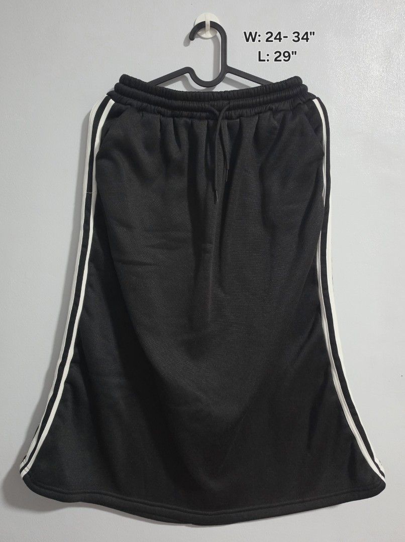 Black Long Skirt with White Side Stripes (Category: Skirts) located in Paranaque City. Submitted by franinnashop (Listing ID 1468372921, Image 1). Description: Declutter - Color: Black with dual white side stripes - Waist: 24 to 34 inches (elastic with adjustable drawstring) - Length: 29 inches - Features: 2 functional side pockets, soft fabric, relaxed fit - Condition: Clean stitching throughout, excellent quality.