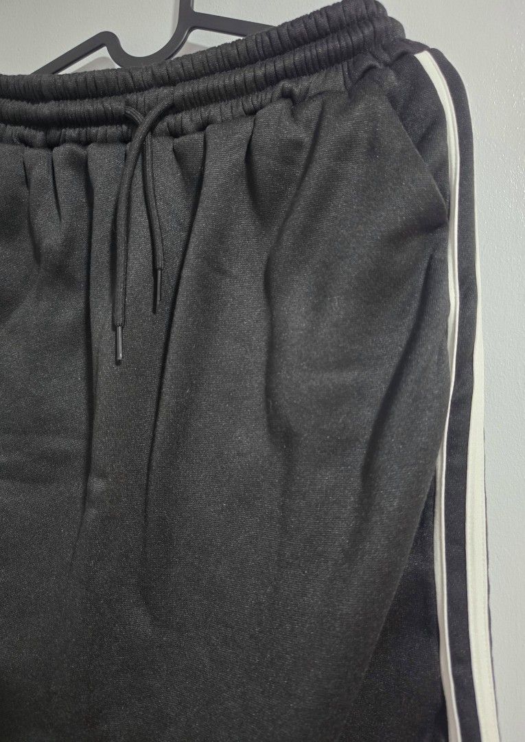 Black Long Skirt with White Side Stripes (Category: Skirts) located in Paranaque City. Submitted by franinnashop (Listing ID 1468372921, Image 2). Description: Declutter - Color: Black with dual white side stripes - Waist: 24 to 34 inches (elastic with adjustable drawstring) - Length: 29 inches - Features: 2 functional side pockets, soft fabric, relaxed fit - Condition: Clean stitching throughout, excellent quality.