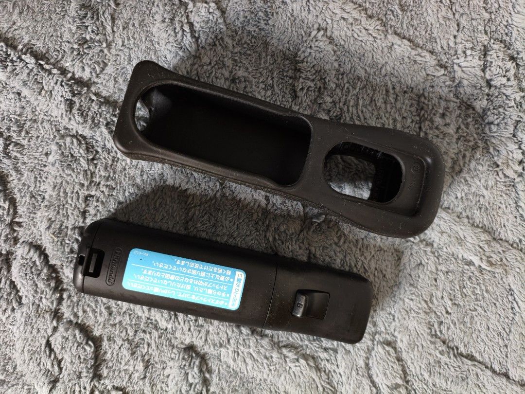 Black Nintendo Wii Remote Controller with Silicone (Category: Controllers) located in Lubao. Submitted by aczcollectibles (Listing ID 1468352649, Image 2). Description: Original black Nintendo Wii Remote with matching silicone case..