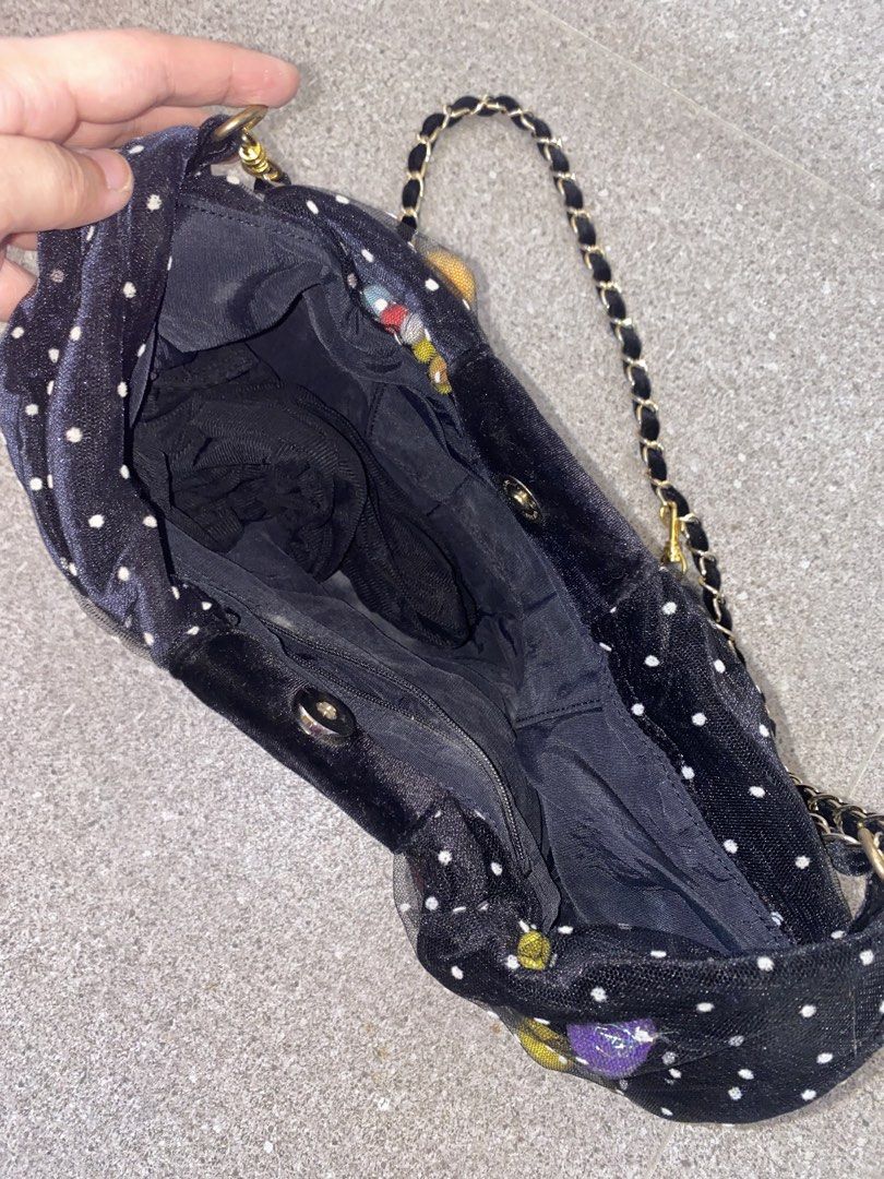 Black Polka Dot Bow Handbag with Chain Strap (Category: Shoulder Bags) located in Pasay City. Submitted by violetttttttttttttt (Listing ID 1468357301, Image 2). Description: Black velvet handbag shaped like a bow with white polka dots. Colorful fuzzy pom-pom embellishments on the right side and bottom left corner. Gold chain strap woven with black ribbon. Zipper closure and fabric lining inside with interior pockets. Removable strap with clasp cl