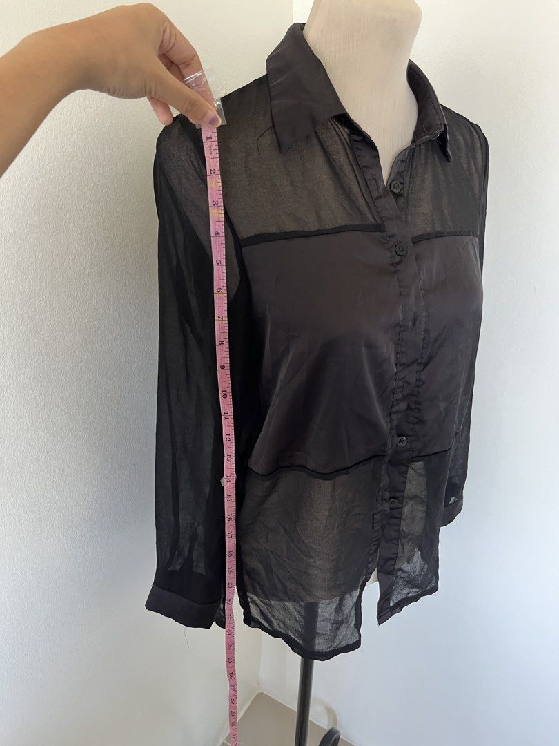 Black Sheer Button-Down Blouse Long Sleeve (Category: Longsleeves) located in Mandaluyong City. Submitted by bravedeer.020ad7 (Listing ID 1468364419, Image 3). Description: - Color & Style: Black sheer button-down shirt with long sleeves and classic collar - Design Details: Horizontal panel accents on front and back yoke - Fit & Sizing: Standard fit, measures roughly 13" across shoulders and 28" in total length - Material: Lightweight fabric feat