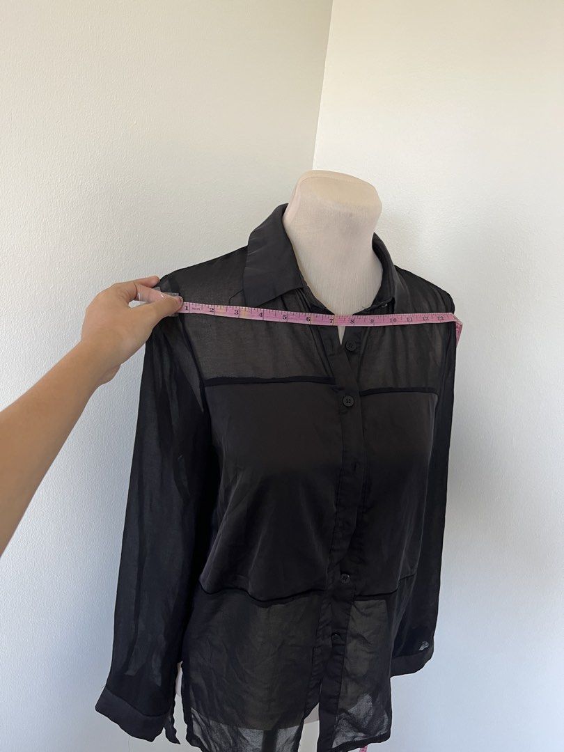 Black Sheer Button-Down Blouse Long Sleeve (Category: Longsleeves) located in Mandaluyong City. Submitted by bravedeer.020ad7 (Listing ID 1468364419, Image 2). Description: - Color & Style: Black sheer button-down shirt with long sleeves and classic collar - Design Details: Horizontal panel accents on front and back yoke - Fit & Sizing: Standard fit, measures roughly 13" across shoulders and 28" in total length - Material: Lightweight fabric feat