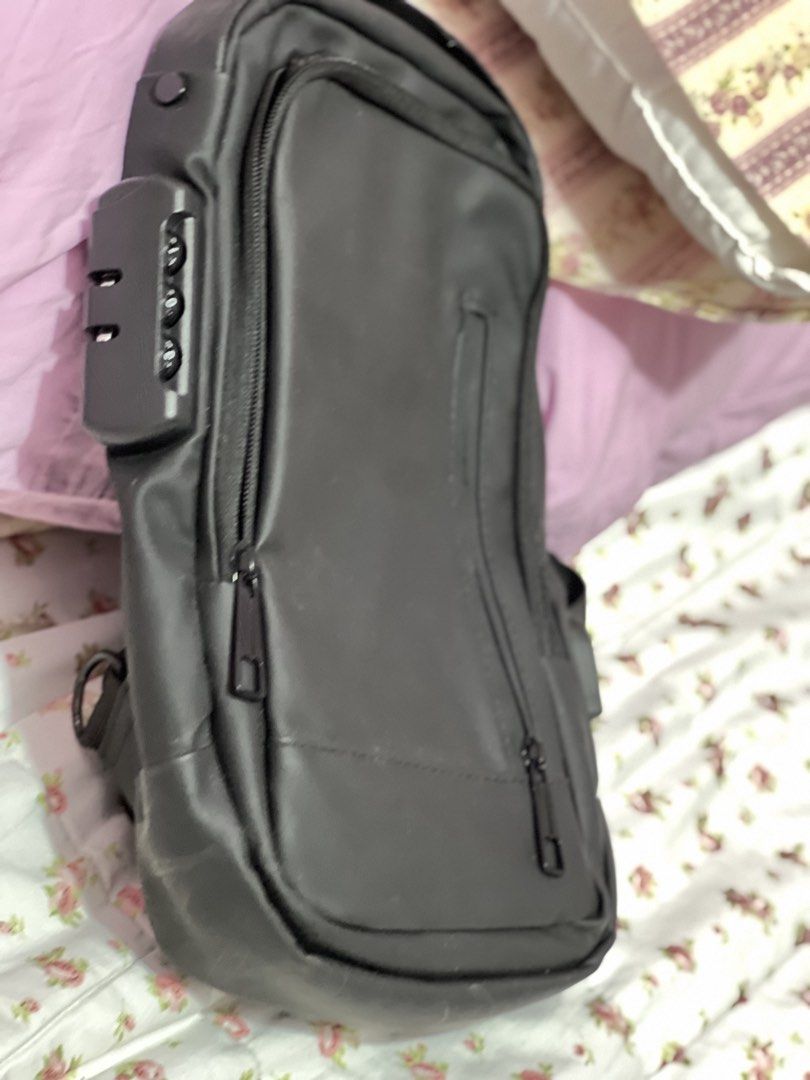 Black Sling Bag with Combination Lock and USB Port (Category: Sling Bags) located in Pasig City. Submitted by morilove (Listing ID 1468303436, Image 1). Description: - Color: Sleek black with a minimalist design - Security: Built-in combination lock to keep your belongings safe - Organization: Multiple zippered compartments both inside and out - Comfort & Durability: Adjustable strap with sturdy D-rings - Versatility: Ideal for daily commuting, t