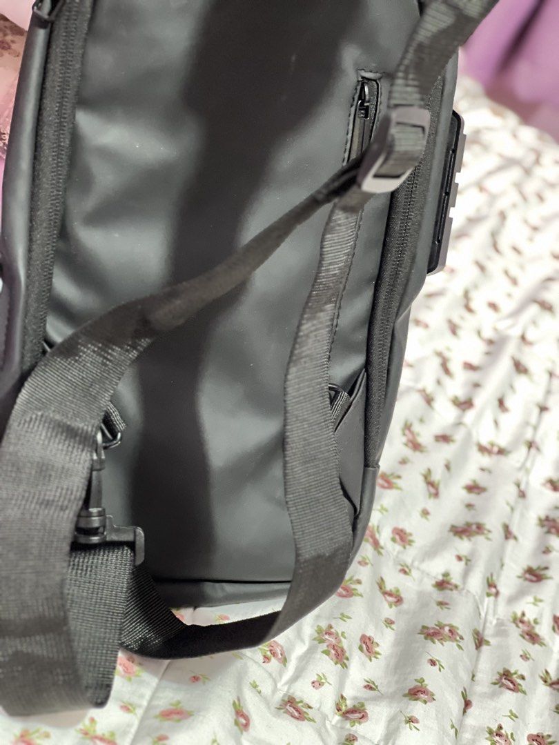 Black Sling Bag with Combination Lock and USB Port (Category: Sling Bags) located in Pasig City. Submitted by morilove (Listing ID 1468303436, Image 3). Description: - Color: Sleek black with a minimalist design - Security: Built-in combination lock to keep your belongings safe - Organization: Multiple zippered compartments both inside and out - Comfort & Durability: Adjustable strap with sturdy D-rings - Versatility: Ideal for daily commuting, t