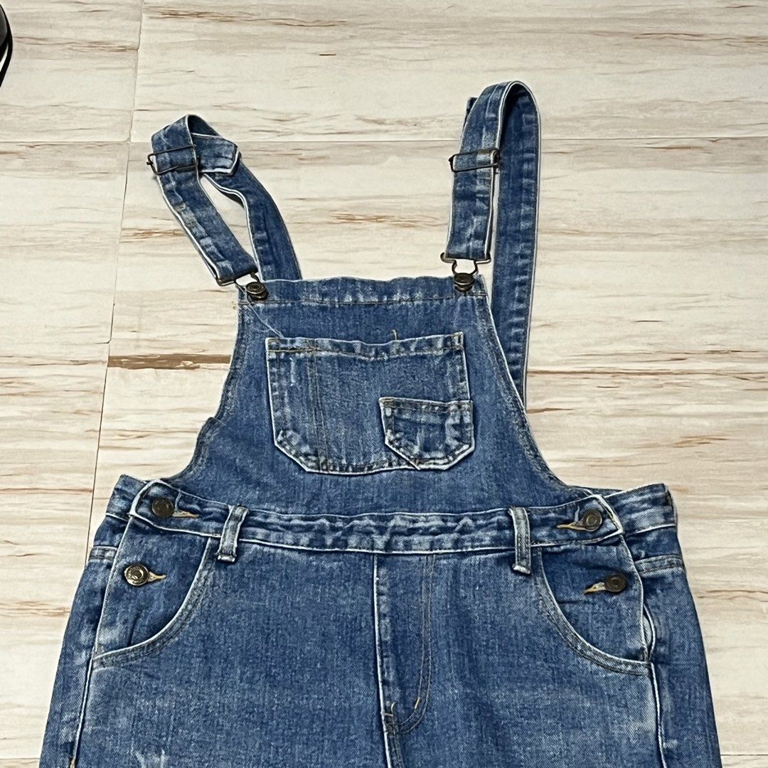 Blue Denim Overalls Jumpsuit with Pockets (Category: Jumpsuits) located in Caloocan City. Submitted by iamqwertyy (Listing ID 1468289219, Image 2). Description: - Style: Classic blue denim overalls -waist : can fit 27-28 - Wash: Medium wash with slight fading at the knees - Fit: Comfortable straight leg - Features: Front bib pocket, side pockets, and adjustable shoulder straps - Details: Classic metal buttons along the sides and chest - Condition