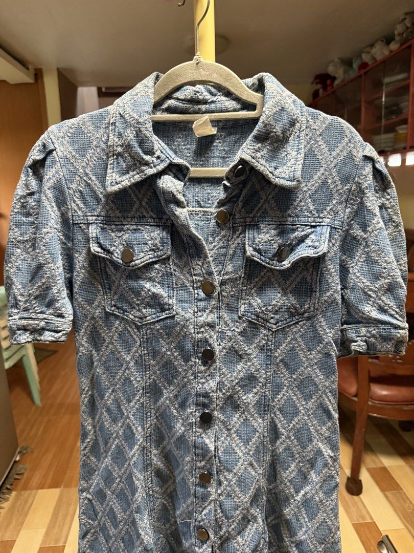Blue Denim Textured Short Sleeve Button Down Dress (Category: Dresses) located in Cebu City. Submitted by hotchkisscebu (Listing ID 1468347535, Image 3). Description: - Style: Blue denim mini dress with all-over diamond pattern - Fit: Structured through the body with short sleeves and gathered shoulders - Details: Front button-up closure with metallic buttons, collared neckline, and fold-up cuffs - Pockets: Two chest flap pockets with button clos