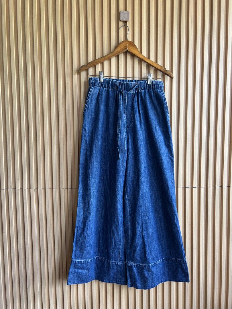 Blue Denim Wide Leg Drawstring Pants (Category: Jeans) located in Lipa City. Submitted by thyra06 (Listing ID 1468321719, Image 1). Description: - Style: Casual wide-leg denim pants - Waist: Elastic waistband with functional front drawstring - Pockets: Two back patch pockets with chic silver V hardware - Wash: Deep blue wash with subtle fading - Details: Thick stitched cuffs at the hem - Fit: Relaxed and comfortable, great for everyday wear.
