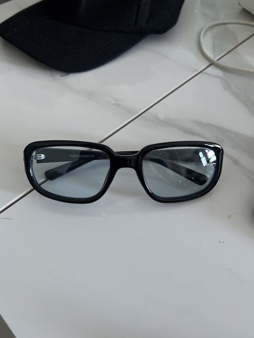 Blue Elephant Black Rectangular Sunglasses (Blue Tint) (Category: Sunglasses & Eyewear) located in Manila. Submitted by puredolphin.8fdf1e (Listing ID 1468288381, Image 1). Description: - Brand: Blue Elephant - Color: Classic black - Frame: Thick acetate, trendy rectangular shape - Lenses: Tinted with subtle brand print inside the top corner - Style: Minimalist and versatile, easy to match with daily outfits - Condition: Brand new / Excellent (re