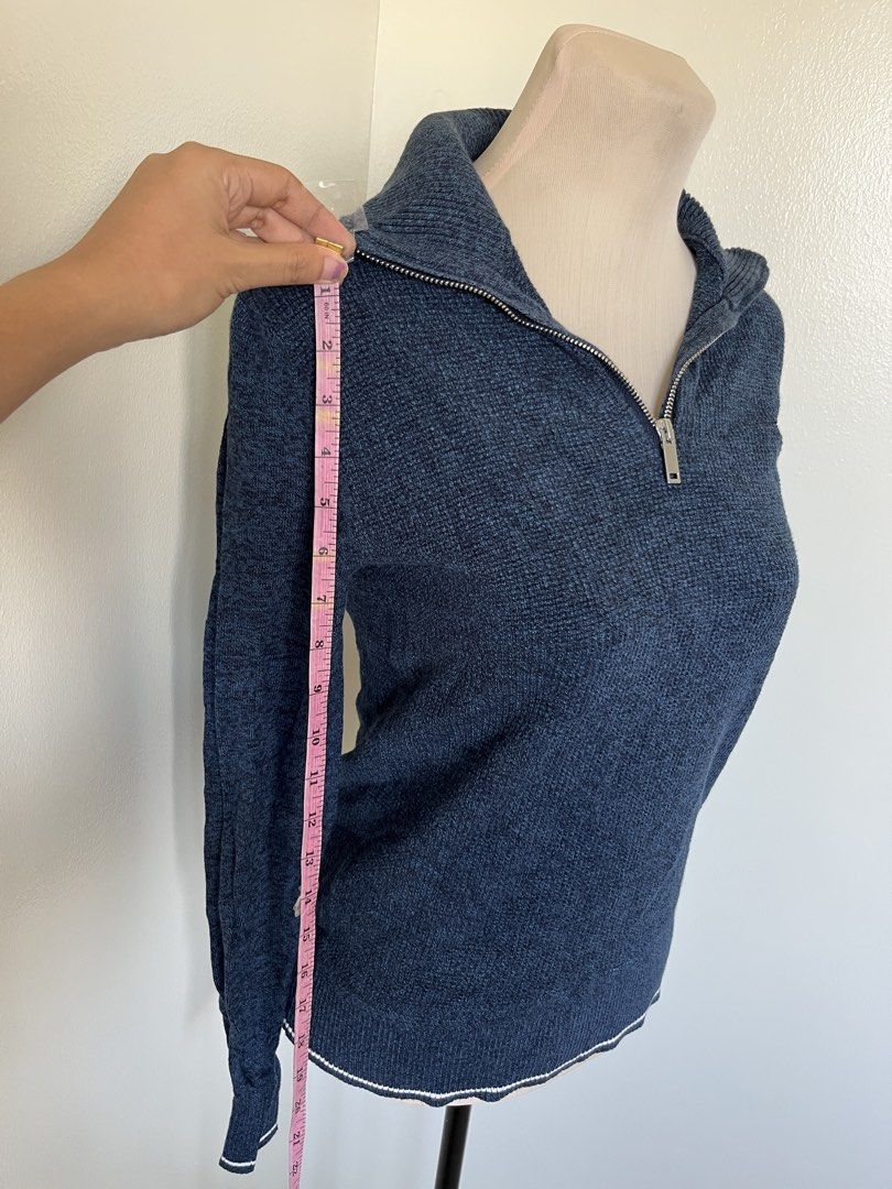 Blue Knit Quarter Zip Pullover Sweater with Collar (Category: Coats, Jackets and Outerwear) located in Mandaluyong City. Submitted by bravedeer.020ad7 (Listing ID 1468368917, Image 2). Description: - Color: Navy blue with white contrast striping on cuffs and hem - Material: Textured knit fabric - Design: Quarter-zip with silver metal zipper pull, fitted long-sleeve silhouette - Measurements: ~21" length from shoulder to hem, ~14" across the chest