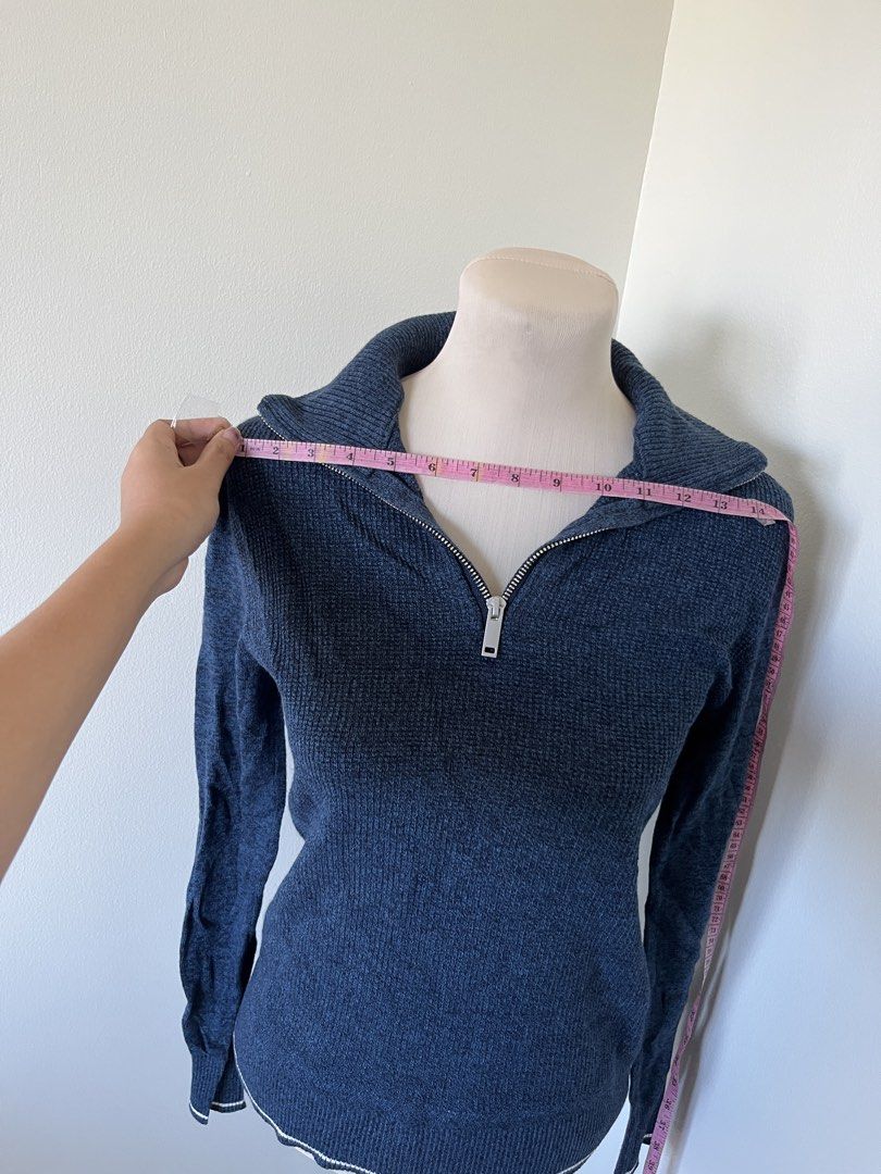 Blue Knit Quarter Zip Pullover Sweater with Collar (Category: Coats, Jackets and Outerwear) located in Mandaluyong City. Submitted by bravedeer.020ad7 (Listing ID 1468368917, Image 3). Description: - Color: Navy blue with white contrast striping on cuffs and hem - Material: Textured knit fabric - Design: Quarter-zip with silver metal zipper pull, fitted long-sleeve silhouette - Measurements: ~21" length from shoulder to hem, ~14" across the chest