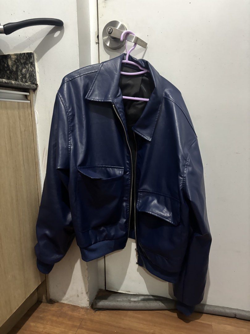 Blue Leather Jacket (Category: Coats, Jackets and Outerwear) located in Batangas. Submitted by preloved_by_rj (Listing ID 1468370055, Image 1). Description: - Color: Dark blue / Solid navy - Material: Smooth faux leather with black interior lining - Closure: Full front zipper - Pockets: Two front pockets with flaps - Details: Standard collar, ribbed hem and cuffs for a snug fit.