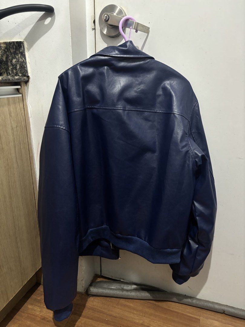 Blue Leather Jacket (Category: Coats, Jackets and Outerwear) located in Batangas. Submitted by preloved_by_rj (Listing ID 1468370055, Image 2). Description: - Color: Dark blue / Solid navy - Material: Smooth faux leather with black interior lining - Closure: Full front zipper - Pockets: Two front pockets with flaps - Details: Standard collar, ribbed hem and cuffs for a snug fit.