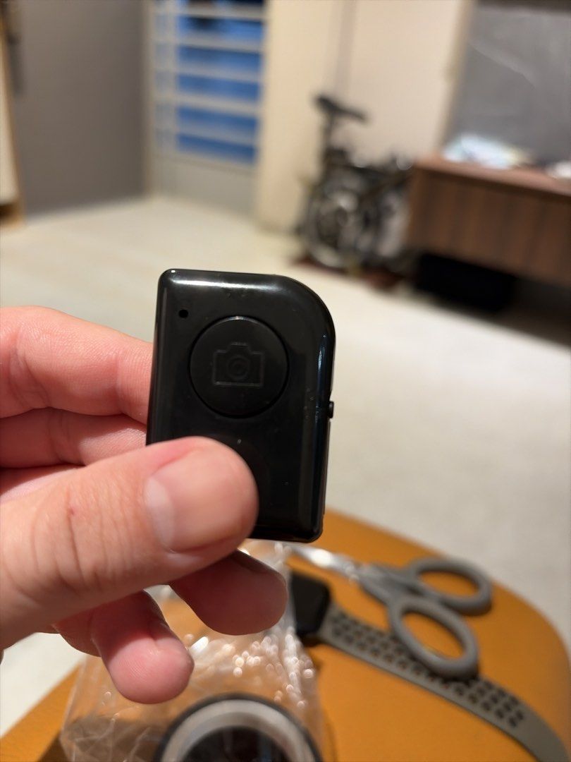 Bluetooth Camera Shutter Remote Control (Category: Cameras) located in Singapore. Submitted by kaikaikai87 (Listing ID 1468392415, Image 1). Description: - Compact black wireless remote shutter for smartphones - Large top button with camera icon for easy shooting - Quick Bluetooth pairing and reliable performance - Perfect for solo content creators, group photos, and tripod setups - Pocket-sized, lightweight, and super handy to carry around.