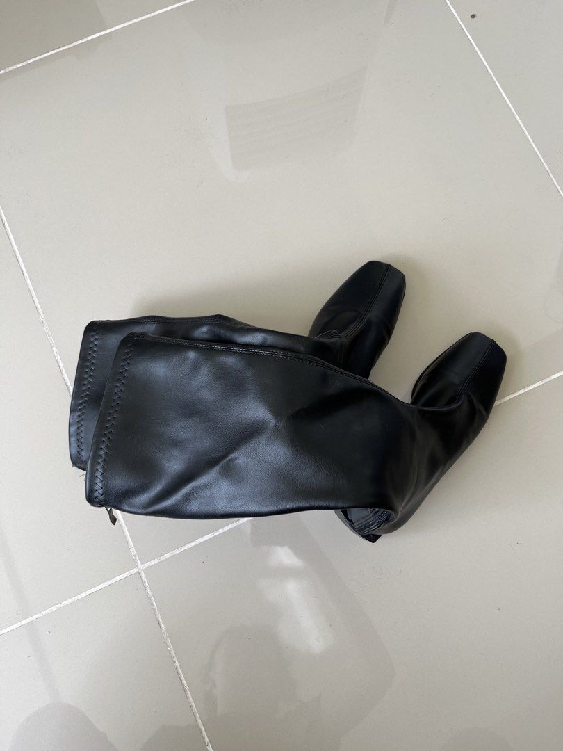 Boots Size 38 (Category: Boots) located in Mandaluyong City. Submitted by bravedeer.020ad7 (Listing ID 1468311352, Image 1). Description: - Size: 38 (stamped on bottom) - Color: Black - Material: Smooth faux leather - Style: Knee-high boots with square toe and chunky block heel - Closure: Side zipper - Condition: Clean soles with light wear on bottom grip - Origin: Made in China.