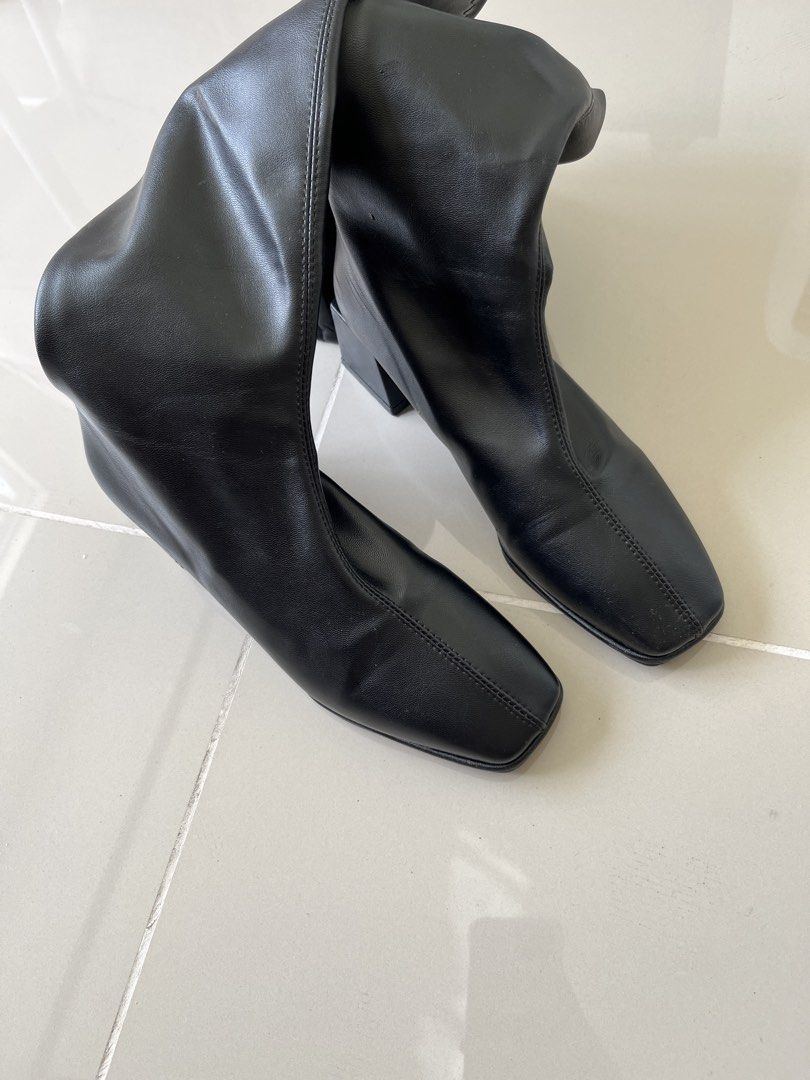 Boots Size 38 (Category: Boots) located in Mandaluyong City. Submitted by bravedeer.020ad7 (Listing ID 1468311352, Image 2). Description: - Size: 38 (stamped on bottom) - Color: Black - Material: Smooth faux leather - Style: Knee-high boots with square toe and chunky block heel - Closure: Side zipper - Condition: Clean soles with light wear on bottom grip - Origin: Made in China.