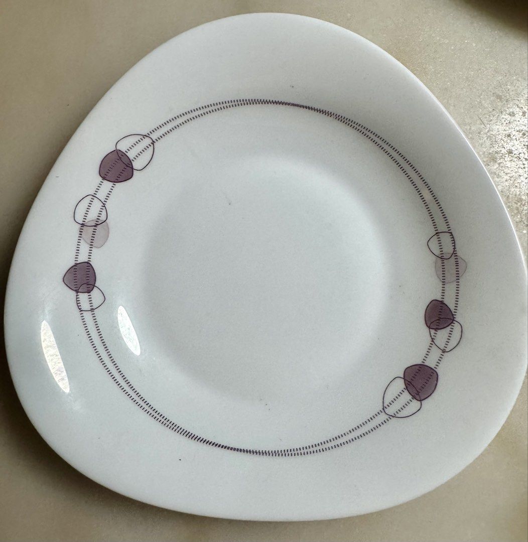 Bormioli Rocco Dinnerware (Category: Dinnerware & Cutlery) located in Paranaque City. Submitted by tripleddd151025 (Listing ID 1468299685, Image 2). Description: 5 pcs dinnerplate 1 pc serving bowl 3 pcs soup bowl - Set of white ceramic bowls with a chic organic triangular shape - Features a stylish purple dotted line and pebble design wrapping the exterior - Deep interior ideal for soups, salads, cereal, and more - Space-saving stackable design 