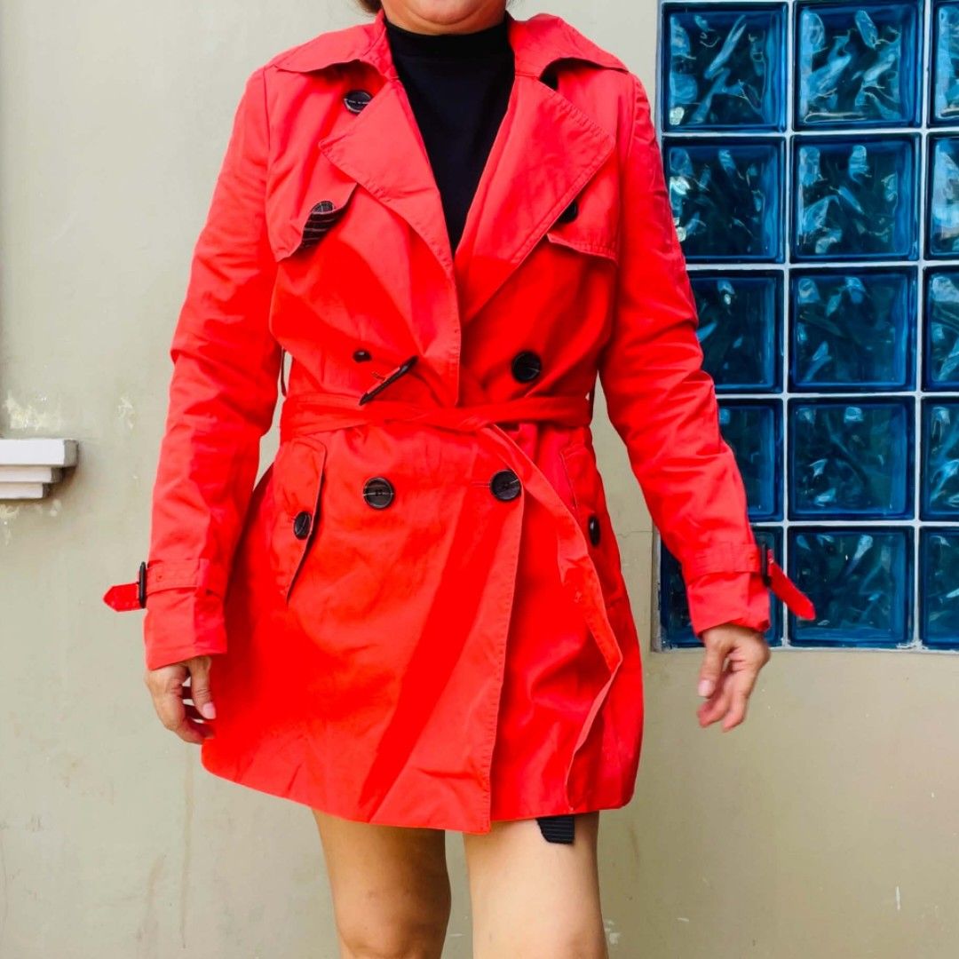 Bright Red Double-Breasted Trench Coat with Belt (Category: Coats, Jackets and Outerwear) located in Bulacan. Submitted by fenph2021 (Listing ID 1468304561, Image 1). Description: - Color: Vibrant red - Style: Double-breasted with classic lapel collar - Details: Dark buttons, matching waist tie belt, and adjustable buckle straps on cuffs - Season: Perfect bright pop of color for cooler/rainy weather M-L.