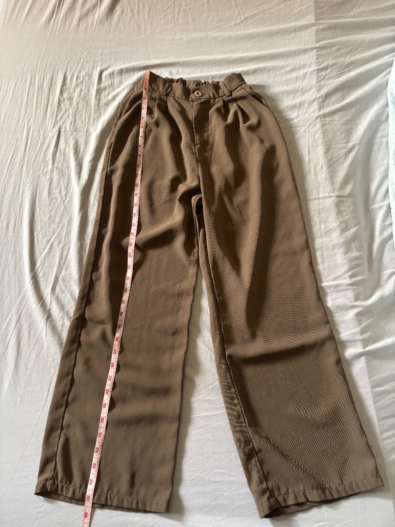 Brown high-waisted trouser pants (Category: Skirts) located in Manila. Submitted by imama23 (Listing ID 1468343387, Image 2). Description: - Color: Brown - Style: High-waisted, pleated, wide leg, - Fit: Relaxed Measurements: - Waist: 20 in. (garterized can fit up to 26in) - Length: 37 in. Condition: 8/10 Location: Manila MOP: GCASH, Bank Transfer Shipping to be shouldered by buyer.