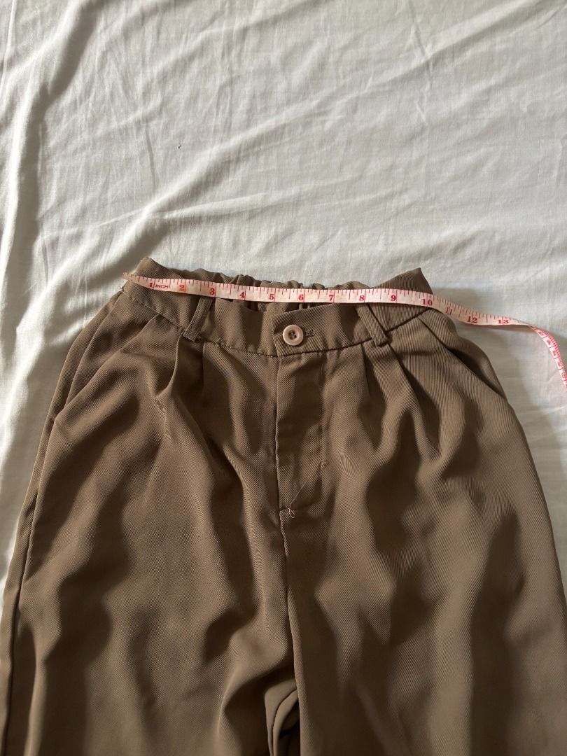 Brown high-waisted trouser pants (Category: Skirts) located in Manila. Submitted by imama23 (Listing ID 1468343387, Image 3). Description: - Color: Brown - Style: High-waisted, pleated, wide leg, - Fit: Relaxed Measurements: - Waist: 20 in. (garterized can fit up to 26in) - Length: 37 in. Condition: 8/10 Location: Manila MOP: GCASH, Bank Transfer Shipping to be shouldered by buyer.