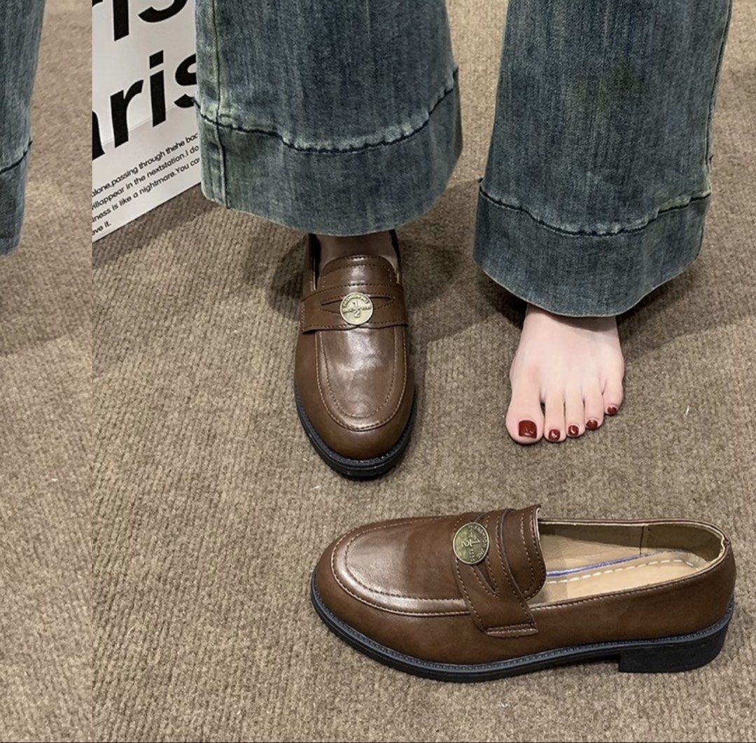 Brown Penny Loafers with Decorative Coin Strap (Category: Loafers) located in Taguig. Submitted by deguzmanke83356 (Listing ID 1468326331, Image 2). Description: - Color & Material: Dark brown faux leather - Minimal Flaw: Glue comes off - Style: Slip-on penny loafers with a decorative metallic coin strap - Sole: Chunky black lug sole with a low block heel - Usage: Versatile casual everyday footwear - Condition: Minor sole separation near the fron