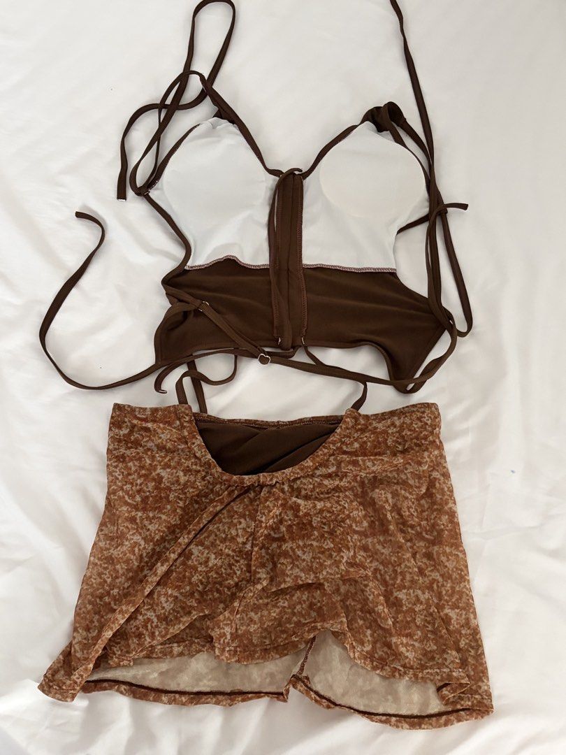 Brown Tankini Size L (Worn Once) (Category: Sets or Coordinates) located in Las Pinas. Submitted by thriftedfinds_ (Listing ID 1468421885, Image 2). Description: - Brown halter corset top with built-in padding and adjustable straps - Includes matching brown patterned mesh mini skirt - Size: Small - Condition: Worn once, freshly washed, and ready to wear - Ideal vacation outfit or stylish pool party cover-up.