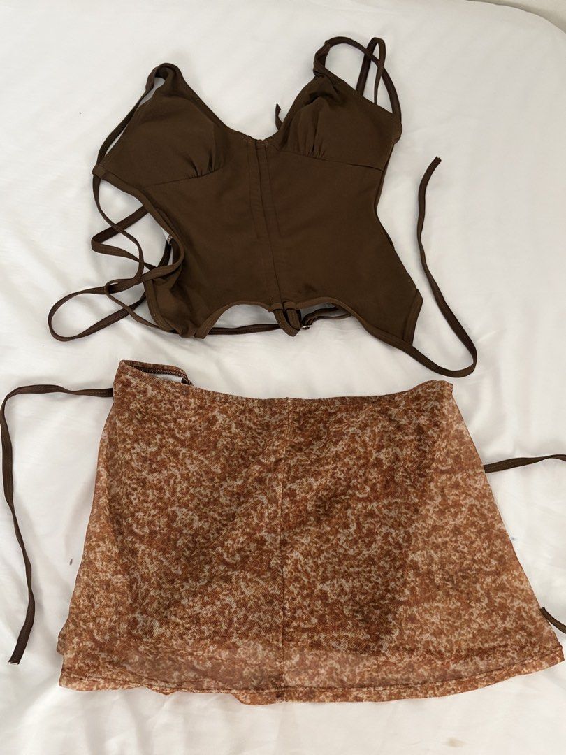 Brown Tankini Size L (Worn Once) (Category: Sets or Coordinates) located in Las Pinas. Submitted by thriftedfinds_ (Listing ID 1468421885, Image 1). Description: - Brown halter corset top with built-in padding and adjustable straps - Includes matching brown patterned mesh mini skirt - Size: Small - Condition: Worn once, freshly washed, and ready to wear - Ideal vacation outfit or stylish pool party cover-up.