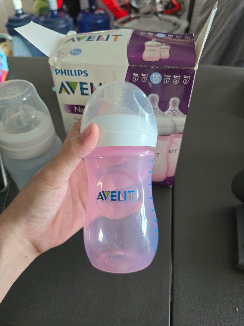 BUNDLE Philips Avent Natural Baby Bottles (Category: Breastfeeding & Bottle Feeding) located in Mandaluyong City. Submitted by _monamourph (Listing ID 1468359312, Image 2). Description: - Brand: Philips Avent Natural - Capacity: 250ml per bottle - Color/Inclusions: 1 pink and 1 clear bottle in original box - Recommended Age: 1m+ with natural latch nipples (#2 and #4 nipples) - Condition: Lightly used ready to use; original box shows minor storage