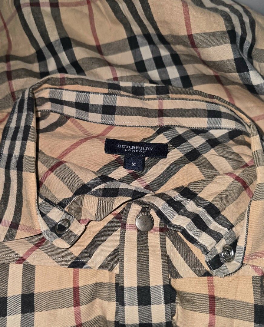 Burberry plaid Polo (Category: Tshirts & Polo Shirts ) located in Hinigaran. Submitted by thrift_street_6106 (Listing ID 1468427744, Image 3). Description: Burberrry polo) Snap Dimes'21'27. Medium Good as new. No issue.