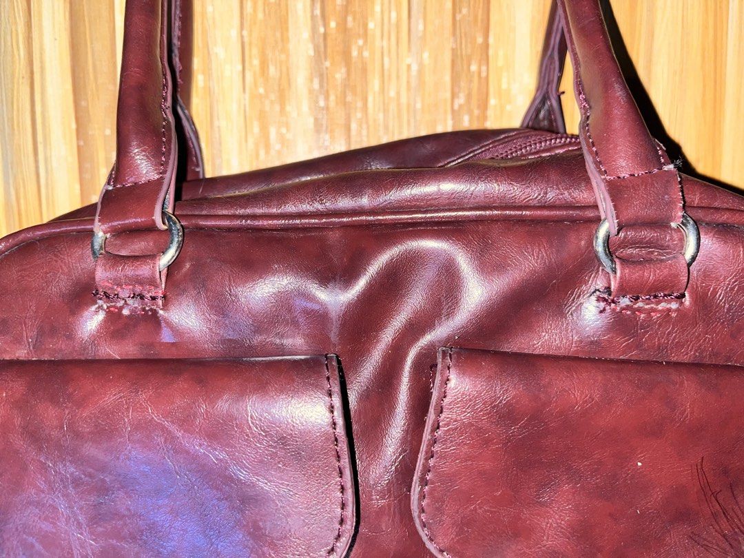 Burgundy Shoulder Bag with Dual Front Pockets (Category: Shoulder Bags) located in Naic. Submitted by nasaryn_ (Listing ID 1468404649, Image 3). Description: Burgundy faux leather shoulder bag with two front flap pockets. Main zip compartment lined in black fabric, fits a compact umbrella easily. Dual shoulder straps attached with silver-tone rings. Clean interior with an extra zippered side pocket. Good everyday size for daily essentials. with f