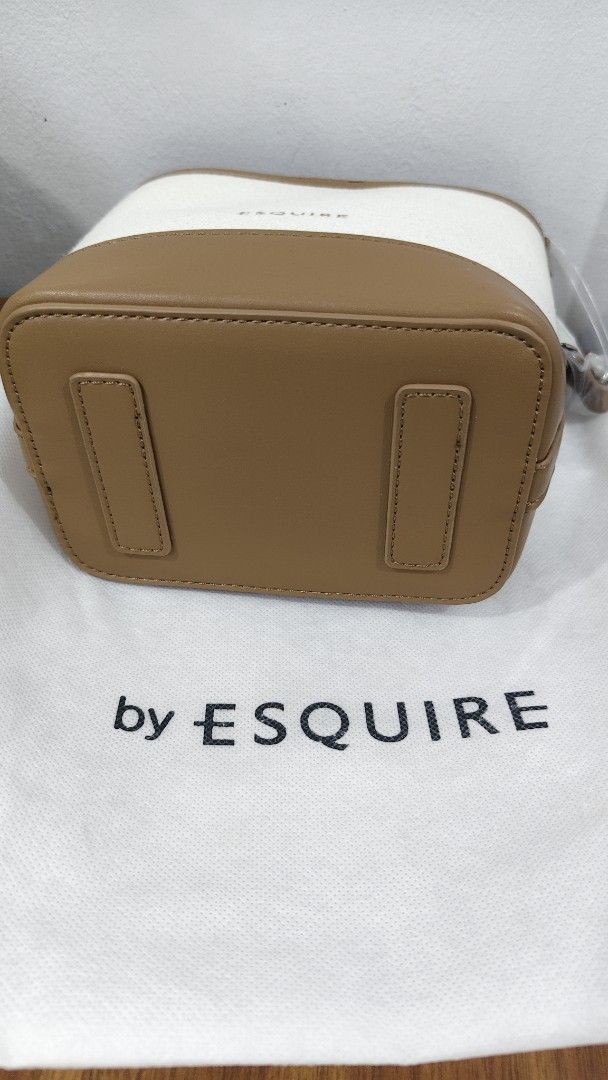 by ESQUIRE Canvas Bucket Bag (Category: Shoulder Bags) located in Manila. Submitted by daisyduck09 (Listing ID 1468362905, Image 3). Description: - Brand: ESQUIRE bucket bag - Color/Material: Cream canvas with brown faux leather trim - Condition: Brand new, never used, with clean interior and exterior (clear protective wrapping still on handle and strap) - Versatility: Includes a short top handle and a detachable, adjustable shoulder strap - Incl