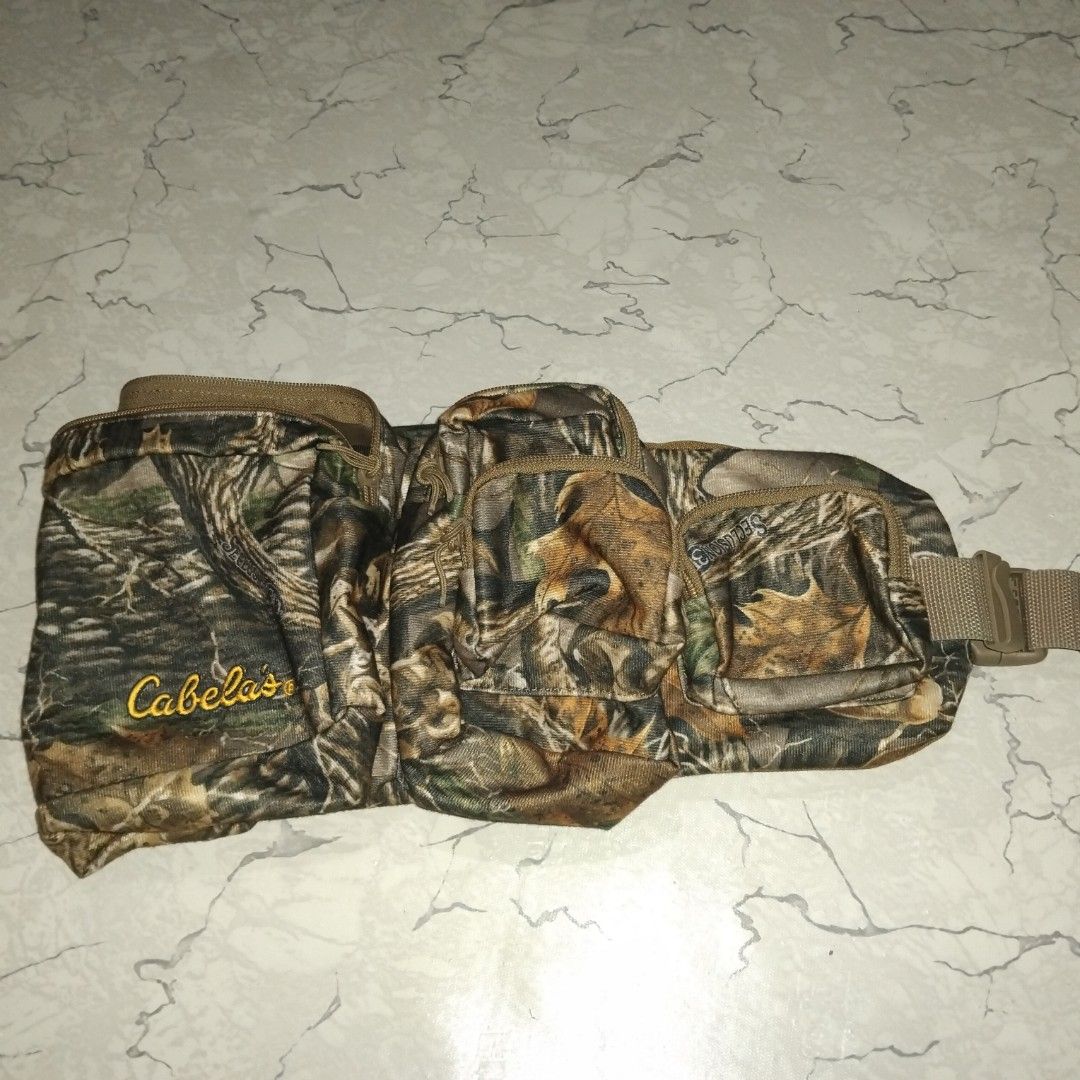 Cabela's Seclusion 3D Camouflage Waist Pack (Category: Belt bags, Clutches and Pouches) located in Manila. Submitted by alexson10 (Listing ID 1468420193, Image 3). Description: - Authentic Cabela's waist pack in Seclusion 3D camouflage pattern - Multiple zippered compartments and front pockets for organized gear storage - Adjustable brown webbed strap with durable branded plastic buckle - Comfortable tan fabric backing on the main compartment - I