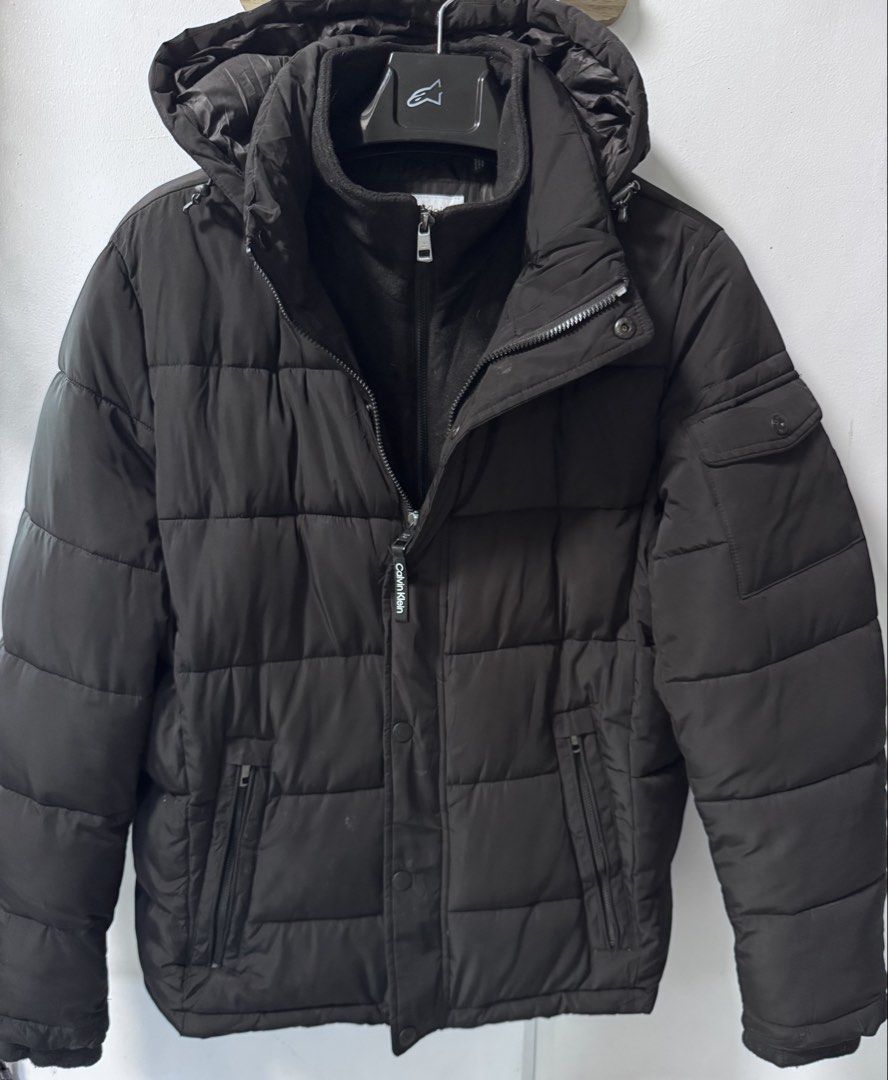 Calvin Klein Black Puffer Jacket with Hood (Category: Coats, Jackets and Outerwear) located in La Trinidad. Submitted by toronnie22 (Listing ID 1468329982, Image 1). Description: Calvin Klein down jacket (puffer) In very good condition NO ISSUE NO ISSUE SIZE ON TAG: Medium men’s COLOR : black COLOR RATE :10/10 DIMENSIONS IN INCHES : L70 W26 1899 plus shipping fee Baguio location Open for video call for legitimacy purposes Ship via j&t - Brand: Ca