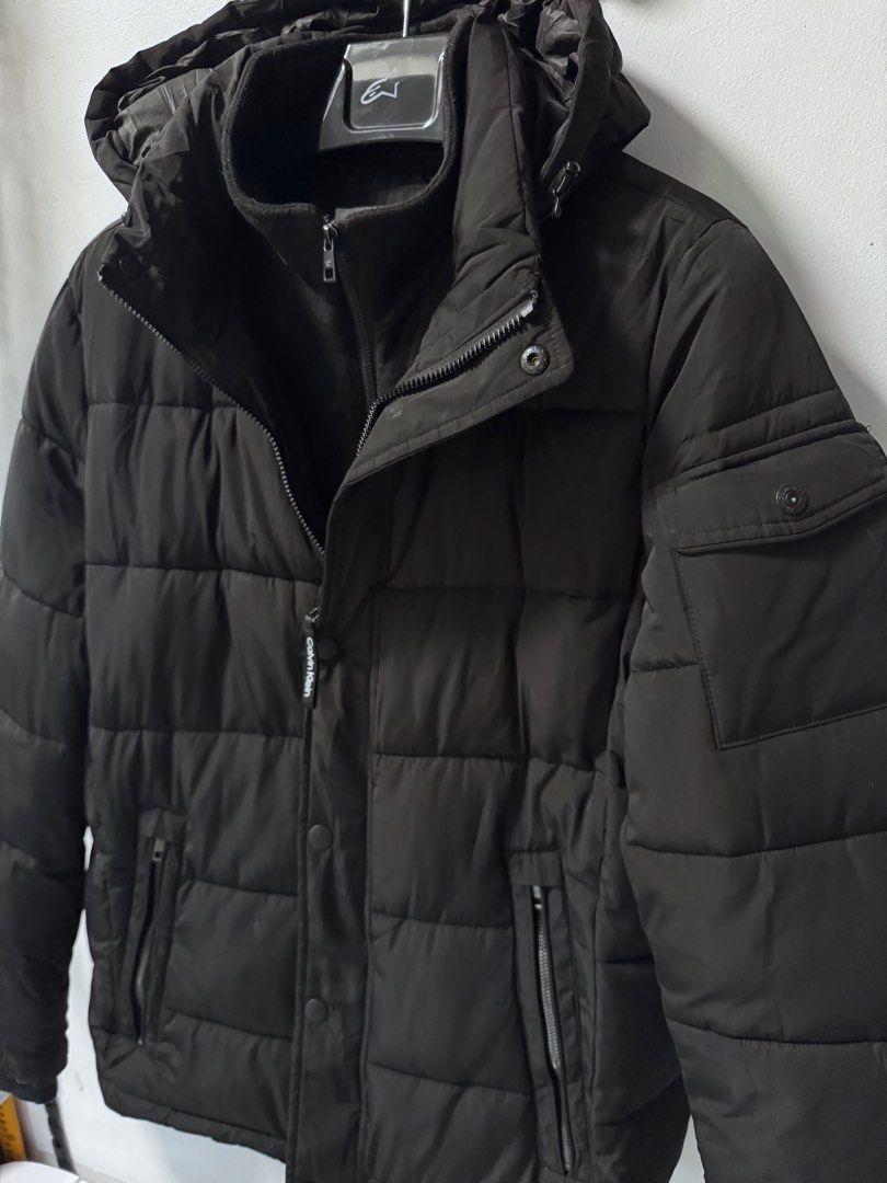 Calvin Klein Black Puffer Jacket with Hood (Category: Coats, Jackets and Outerwear) located in La Trinidad. Submitted by toronnie22 (Listing ID 1468329982, Image 2). Description: Calvin Klein down jacket (puffer) In very good condition NO ISSUE NO ISSUE SIZE ON TAG: Medium men’s COLOR : black COLOR RATE :10/10 DIMENSIONS IN INCHES : L70 W26 1899 plus shipping fee Baguio location Open for video call for legitimacy purposes Ship via j&t - Brand: Ca