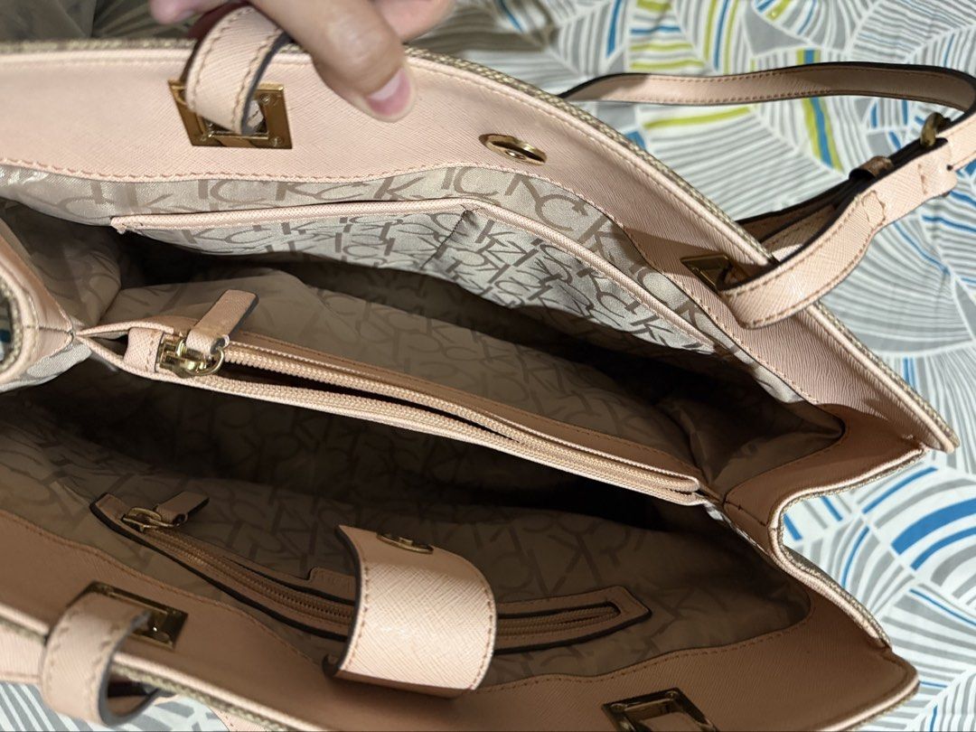 Calvin Klein Monogram Tote Bag Brown and Pink (Category: Tote Bags) located in Tacloban City. Submitted by chrischanah (Listing ID 1468477775, Image 3). Description: - Authentic Calvin Klein tote bag in a stylish brown monogram print - Accented with chic pink straps, trim, and elegant gold hardware - Organized interior featuring multiple compartments and a secure zipped middle section - Convenient exterior slip pocket on the front for easy access