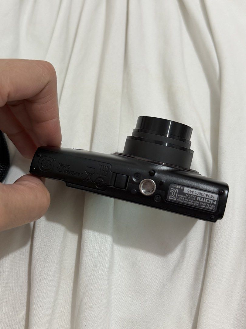 Canon IXUS 285 HS A Digital Camera (Category: Cameras) located in Bacoor. Submitted by everything_etc. (Listing ID 1468461377, Image 2). Description: - Model: Canon IXUS 285 HS (Black) - Condition: Fully working, normal handling marks on the body - Lens: 12x optical zoom for versatile shooting - Connectivity: Built-in Wi-Fi for easy photo transfer - Video: Full HD capability - Design: Standard button layout with rear LCD screen and bottom battery