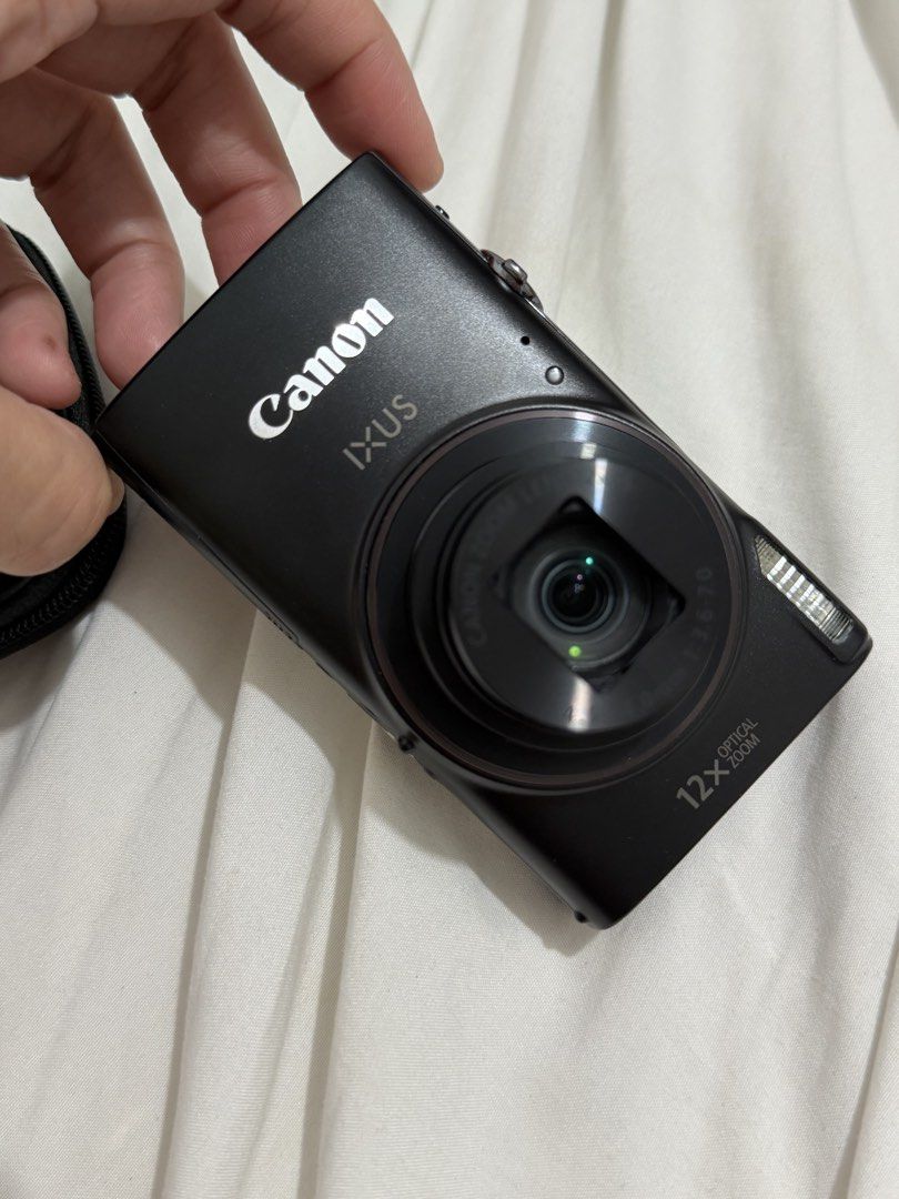 Canon IXUS 285 HS A Digital Camera (Category: Cameras) located in Bacoor. Submitted by everything_etc. (Listing ID 1468461377, Image 1). Description: - Model: Canon IXUS 285 HS (Black) - Condition: Fully working, normal handling marks on the body - Lens: 12x optical zoom for versatile shooting - Connectivity: Built-in Wi-Fi for easy photo transfer - Video: Full HD capability - Design: Standard button layout with rear LCD screen and bottom battery