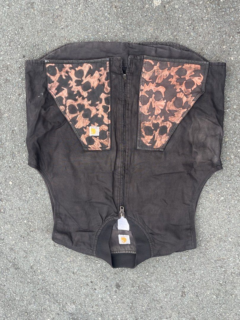 Carhartt Custom Bleached Skull Pattern Zip Up Vest (Category: Vests) located in Marikina City. Submitted by baron0923 (Listing ID 1468454442, Image 1). Description: - Brand: Carhartt - Style: Zip-up canvas vest with ribbed collar - Color: Black with worn-in wash - Customization: Bleach-discharge skull pattern on upper chest - Details: Front zipper closure and iconic Carhartt logo patches on chest and collar - Material: Heavy-duty canvas fabric - 