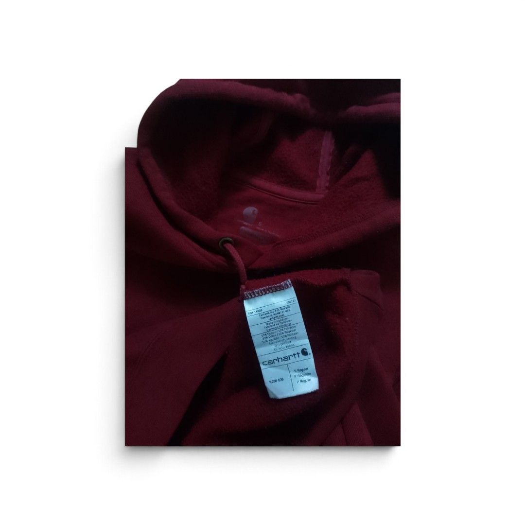 Carhartt Red Sleeve Logo Pullover Hoodie Size S (Category: Hoodies) located in Bacolod City. Submitted by rodzthrift (Listing ID 1468323472, Image 3). Description: - Brand: Carhartt - Style: Pullover hoodie with adjustable drawstring hood and front pouch pocket - Color: Deep red - Size: S Regular - Material: 50% cotton, 50% polyester (warm, heavyweight fabric) - Details: Bold silver Carhartt lettering on the left sleeve and signature logo patch o