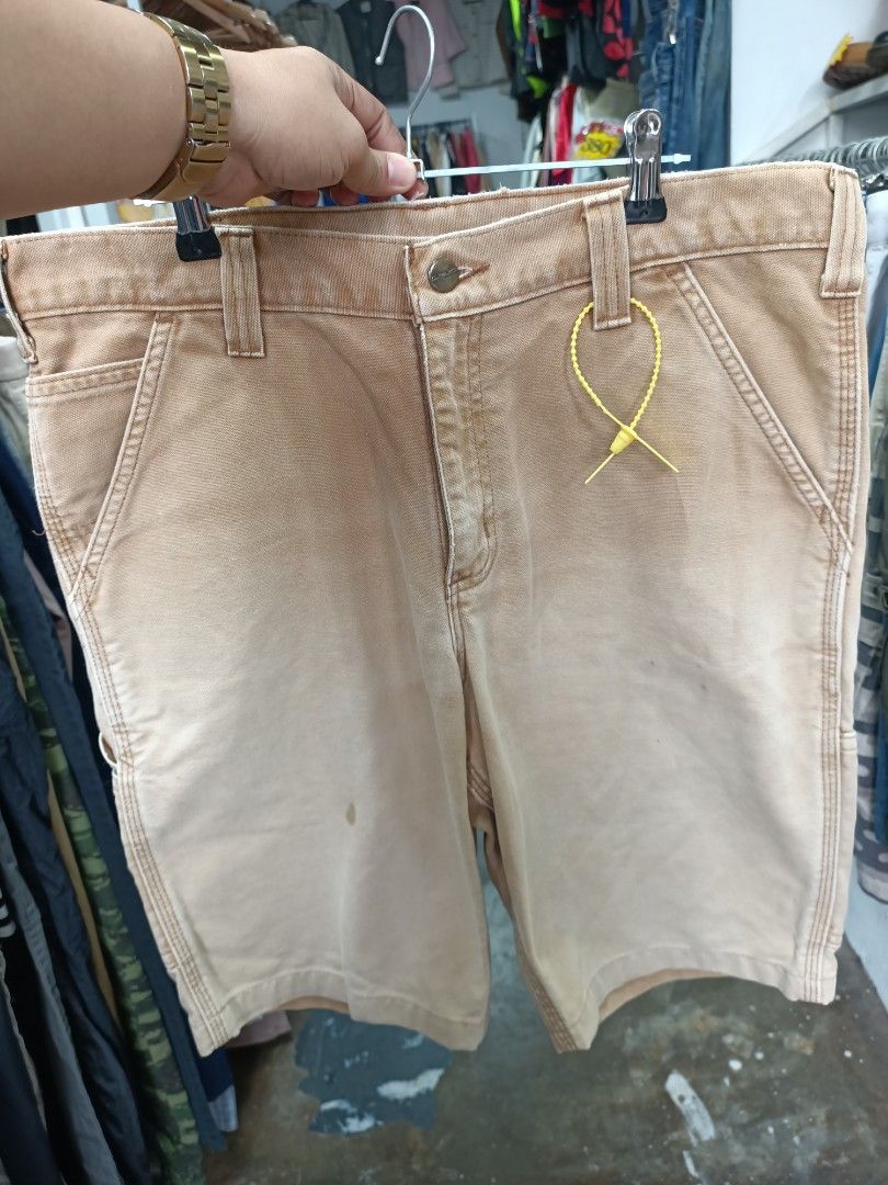 Carhartt Work in Progress Tan Duck Canvas Shorts (Category: Shorts) located in Bayombong. Submitted by rheaaa00530 (Listing ID 1468300876, Image 1). Description: - Brand: Carhartt - Material: Heavy-duty cotton canvas - Color: Tan - Features: Front slash pockets, belt loops, button waist with zipper fly - Condition: Classic workwear style with natural fading and minor wear spots - Best for: Outdoor work or casual everyday wear -size 35 via tape me