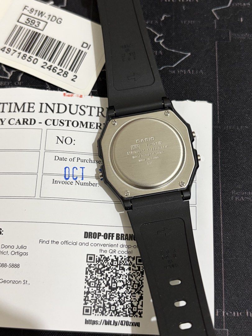Casio F-91W Digital Watch (Category: Men's Watches) located in Taguig. Submitted by nivla23 (Listing ID 1468356100, Image 2). Description: Selling Casio F-91W - Brand: Classic Casio digital watch in black - Condition: Brand new, unworn, with original packaging and tag - Warranty: Includes warranty card dated October 14, 2026 - Design: Lightweight and comfortable resin strap with a clear digital display - Features: Built-in daily alarm and stopwat