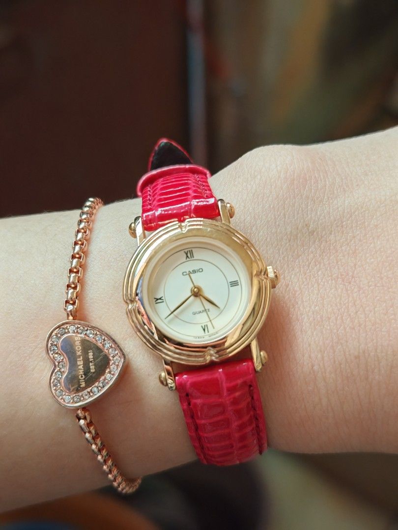 Casio LTP-1106 Gold Watch (Category: Women's Watches) located in Taguig. Submitted by mystuff4youph (Listing ID 1468362479, Image 1). Description: - Brand: Casio women's watch - Design: Gold-tone case gold dial and Roman numerals (XII, IX, VI) - Replaced Strap: Bright red textured leather with standard buckle closure - Movement: Quartz movement, keeps time accurately - Build: Stainless steel back, water-resistant - Condition: Works great, like ne