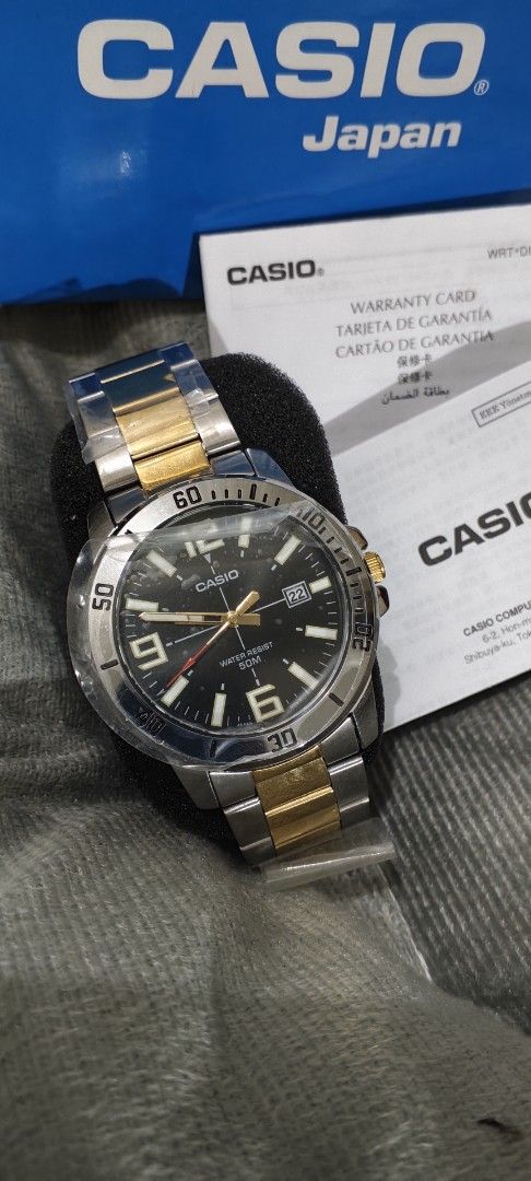 Casio MTP-VD01SG Two-Tone Watch (Category: Men's Watches) located in Manila. Submitted by burgerpatti (Listing ID 1468462168, Image 2). Description: - Brand: Casio MTP-VD01 Analog Watch - Design: Two-tone silver and gold stainless steel band with a sleek black dial - Features: Numeric markers at 6, 9, and 12, plus a convenient date window - Water Resistance: Up to 50 meters - Condition: Brand new with protective plastic film still wrapped around 