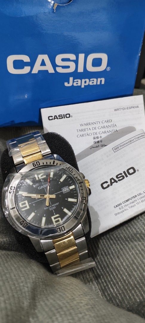 Casio MTP-VD01SG Two-Tone Watch (Category: Men's Watches) located in Manila. Submitted by burgerpatti (Listing ID 1468462168, Image 3). Description: - Brand: Casio MTP-VD01 Analog Watch - Design: Two-tone silver and gold stainless steel band with a sleek black dial - Features: Numeric markers at 6, 9, and 12, plus a convenient date window - Water Resistance: Up to 50 meters - Condition: Brand new with protective plastic film still wrapped around 