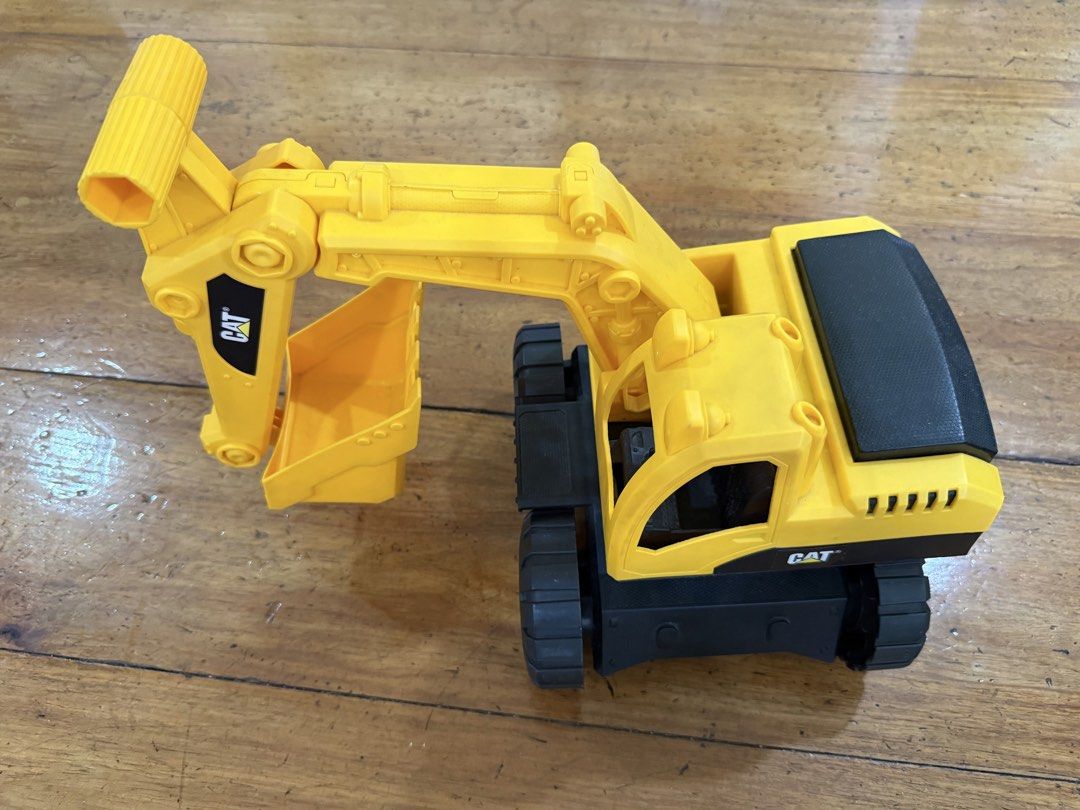 CAT Construction Toy Excavator (Category: Kids Toys) located in Quezon City. Submitted by ajajbaby (Listing ID 1468499277, Image 1). Description: - Authentic yellow and black CAT toy excavator - Fully movable arm and bucket for realistic play - Sturdy plastic tracks on both sides for durability - Features classic Caterpillar branding on the side and boom - Great for both indoor and outdoor fun.
