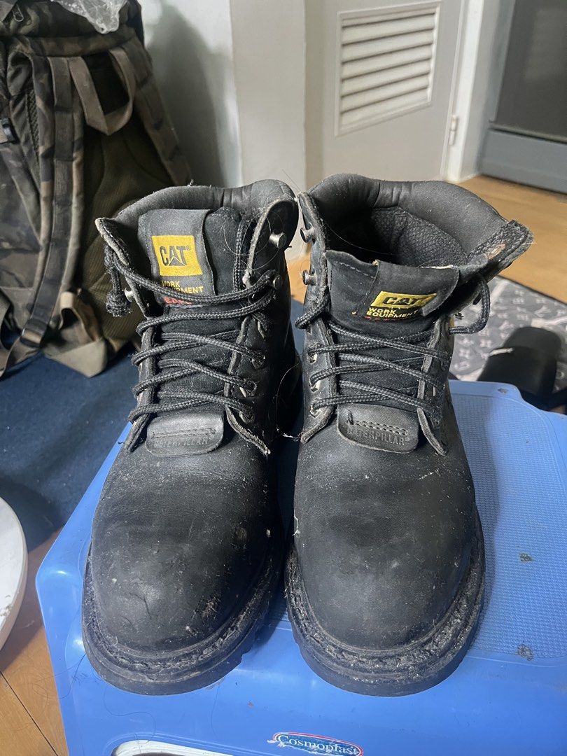 Caterpillar Black Work Boots (Category: Boots) located in Marikina City. Submitted by baron0923 (Listing ID 1468453980, Image 1). Description: - Brand: Caterpillar (CAT) - Color: Black with yellow paint splatters and iconic yellow logos - Style: Heavy-duty work boots with lace-up closure, metal eyelets, and speed hooks - Features: Sturdy build, thick lug soles, and comfortable padded collars - Condition: Heavy wear with visible dirt and scuffs ac