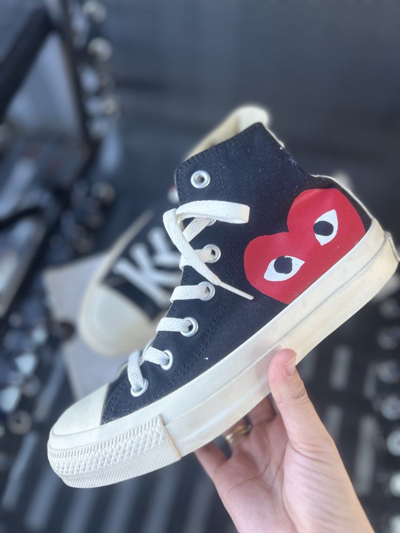 CDG Play x Converse Chuck Taylor High Top Black (Category: Sneakers) located in Quezon City. Submitted by cheriesonlineshop (Listing ID 1468462627, Image 1). Description: - Brand: Comme des Garçons Play x Converse - Style: Black High Top Sneakers - Design: Iconic red heart and eyes graphic on the side - Details: White rubber toe cap, contrast back seam stitching, and classic All Star branding. Needs cleaning Bought in Japan for ₱9500 - Inclusions